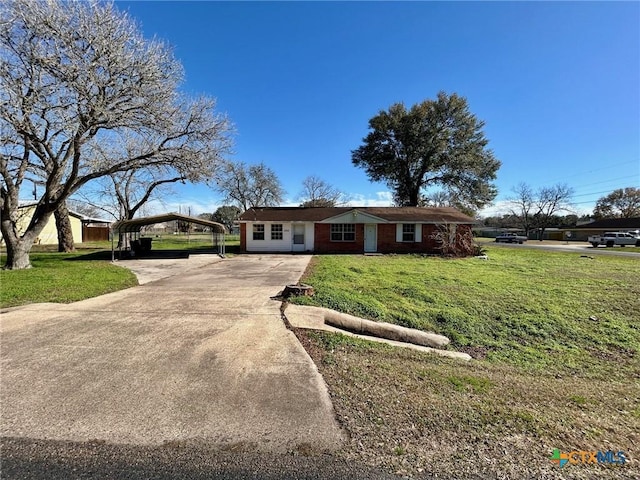 ranch-style house featuring a carport and a front lawn