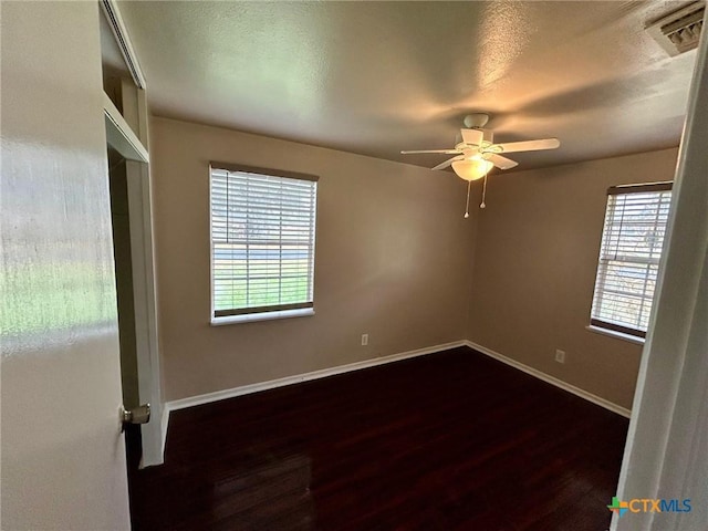 305 Larkspur St, Victoria, TX 77904 - unfurnished room with baseboards, a textured ceiling, dark wood finished floors, and a ceiling fan