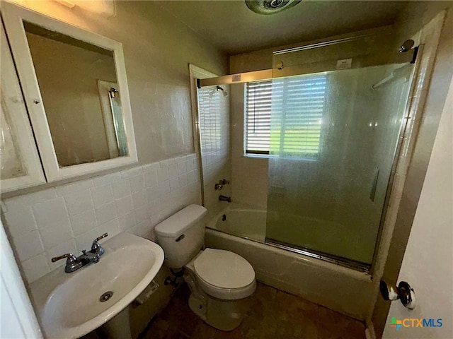 305 Larkspur St, Victoria, TX 77904 - full bathroom featuring tile walls, enclosed tub / shower combo, and wainscoting