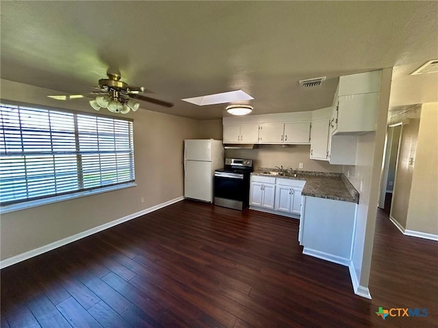 kitchen featuring sink, white cabinetry, a skylight, white refrigerator, and stainless steel electric range oven