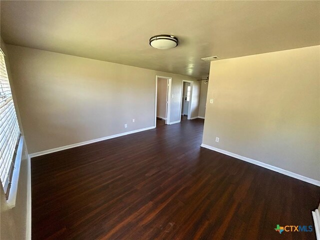 305 Larkspur St, Victoria, TX 77904 - empty room with dark wood-style flooring and baseboards