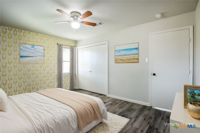 bedroom featuring dark hardwood / wood-style flooring, a closet, and ceiling fan