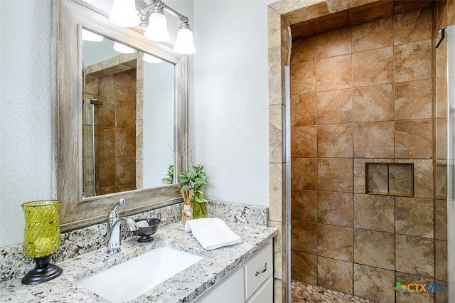 bathroom with vanity and a shower with shower door