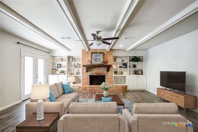 living room featuring beamed ceiling, ceiling fan, a fireplace, dark hardwood / wood-style flooring, and french doors