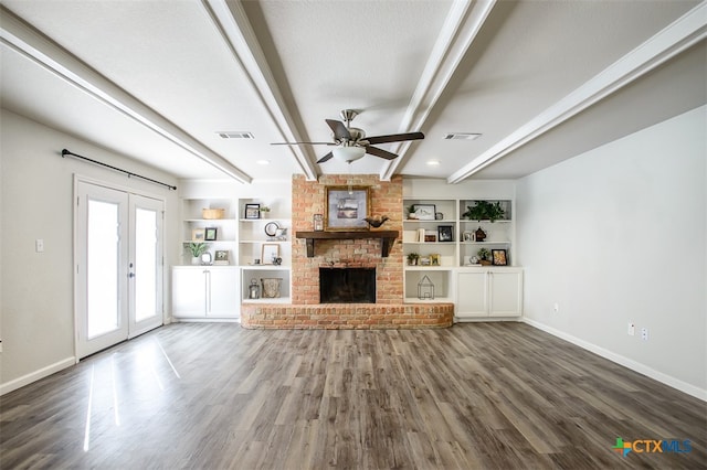 unfurnished living room with dark hardwood / wood-style flooring, beamed ceiling, french doors, and ceiling fan