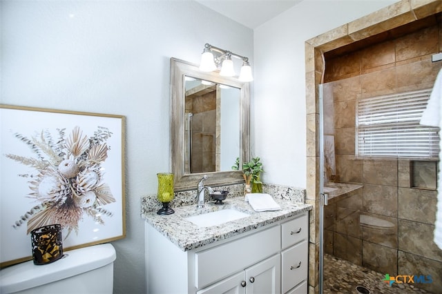 bathroom featuring vanity, toilet, and an enclosed shower