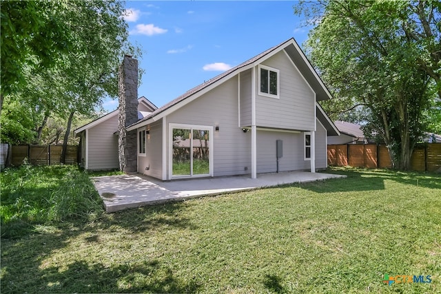 rear view of property featuring a patio area and a yard