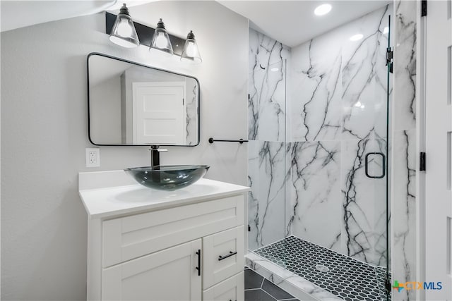 bathroom featuring tile patterned floors, vanity, and a shower with shower door