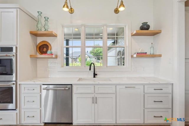 127 Cumberland Dr, Belton, TX 76513 - kitchen featuring open shelves, stainless steel appliances, a sink, and light stone counters