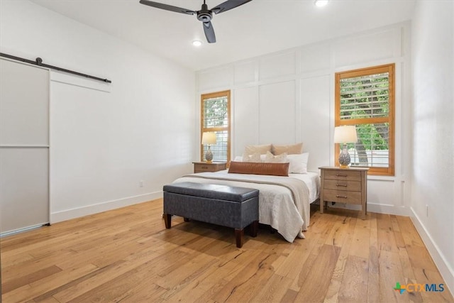 127 Cumberland Dr, Belton, TX 76513 - bedroom featuring light wood finished floors, a barn door, recessed lighting, ceiling fan, and baseboards
