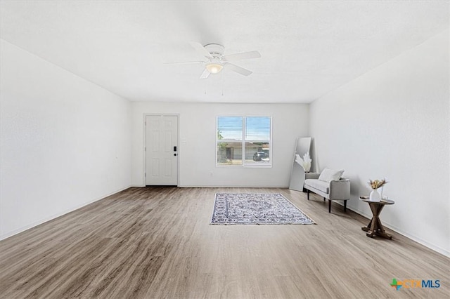 unfurnished room with light wood-type flooring and ceiling fan