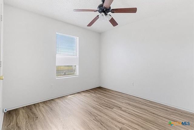 unfurnished room with a textured ceiling, ceiling fan, and light hardwood / wood-style flooring