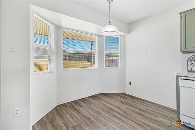 unfurnished dining area featuring light hardwood / wood-style flooring and a wealth of natural light