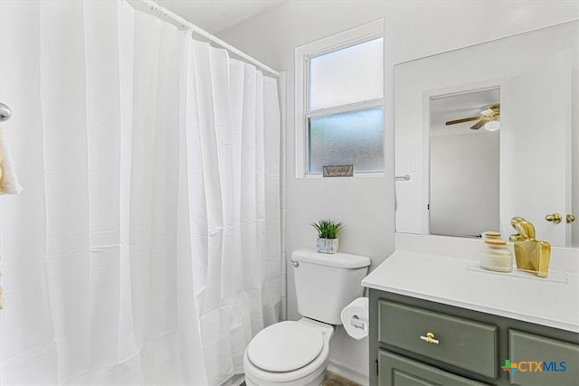 bathroom featuring ceiling fan, curtained shower, vanity, and toilet