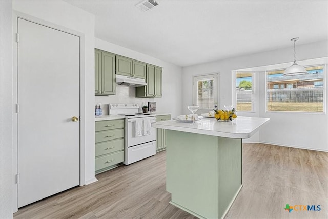 kitchen featuring green cabinets, light hardwood / wood-style floors, pendant lighting, electric range, and a kitchen island with sink