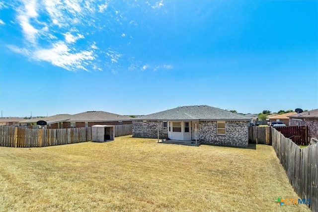 rear view of house featuring a lawn