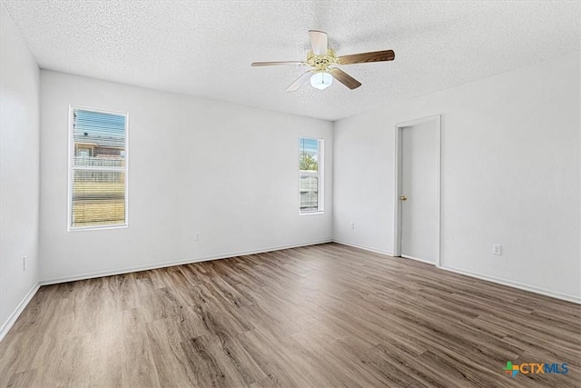 unfurnished room with hardwood / wood-style flooring, a textured ceiling, and ceiling fan