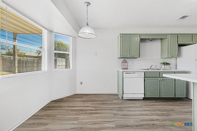 kitchen with white appliances, sink, decorative light fixtures, and green cabinets