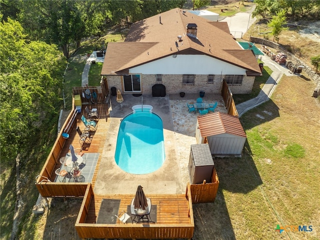 view of swimming pool featuring a patio area, a yard, and a deck