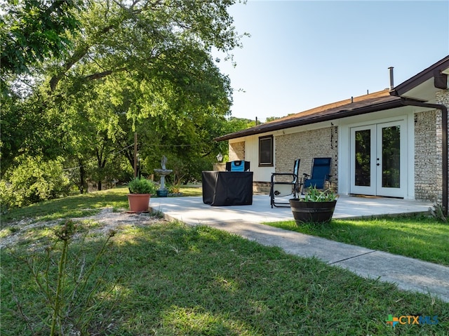 view of yard with a patio and french doors