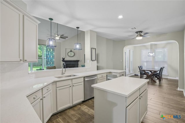 2604 Whitehurst Dr, Round Rock, TX 78681 - kitchen with a ceiling fan, dishwasher, arched walkways, light countertops, and dark wood-type flooring