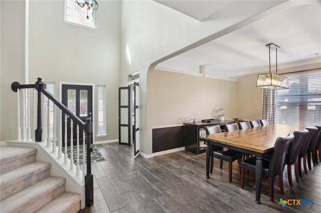 2604 Whitehurst Dr, Round Rock, TX 78681 - dining room featuring arched walkways, healthy amount of natural light, dark wood-style floors, and stairs