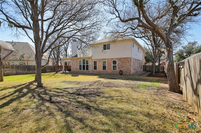 2604 Whitehurst Dr, Round Rock, TX 78681 - back of house featuring brick siding, a chimney, and a fenced backyard