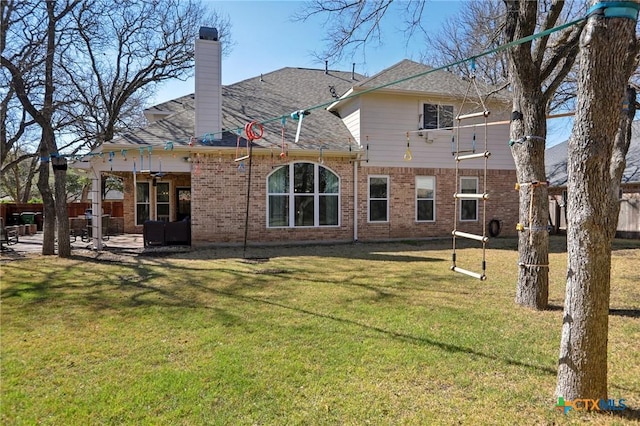 2604 Whitehurst Dr, Round Rock, TX 78681 - rear view of property with a patio area, brick siding, a lawn, ceiling fan, and a chimney