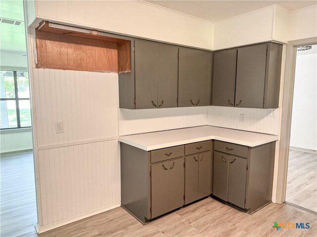 7260 Fm 531, Hallettsville, TX 77964 - kitchen featuring gray cabinets, light wood-style floors, light countertops, and crown molding
