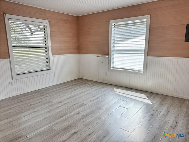 7260 Fm 531, Hallettsville, TX 77964 - spare room featuring wainscoting, healthy amount of natural light, wood finished floors, and wood walls