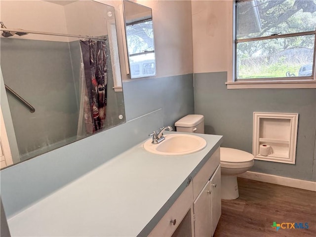 7260 Fm 531, Hallettsville, TX 77964 - bathroom featuring healthy amount of natural light, toilet, wood finished floors, and a shower with curtain
