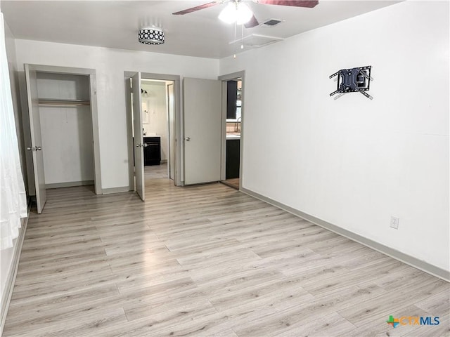 7260 Fm 531, Hallettsville, TX 77964 - unfurnished bedroom with light wood-style floors, baseboards, a closet, and a ceiling fan