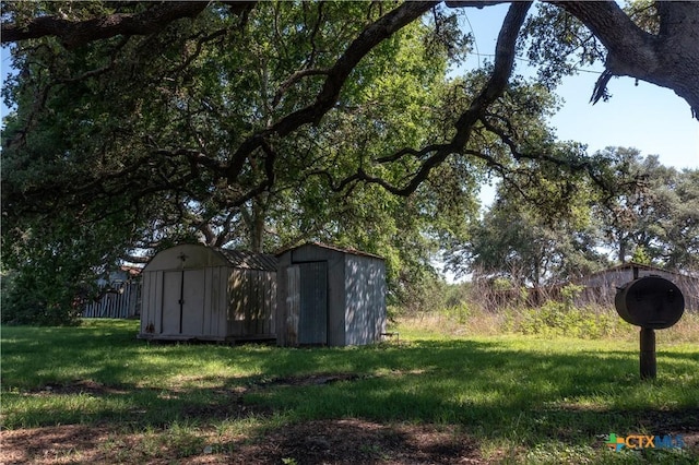 7260 Fm 531, Hallettsville, TX 77964 - view of green lawn featuring a storage unit and an outdoor structure