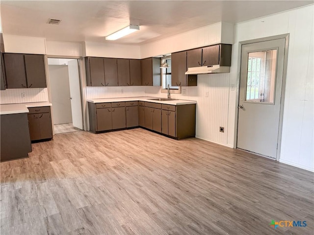 7260 Fm 531, Hallettsville, TX 77964 - kitchen featuring light wood-type flooring, healthy amount of natural light, light countertops, and a sink