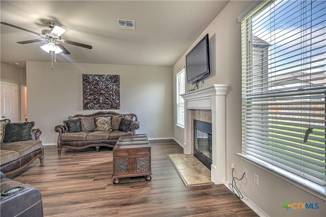 5810 Ambrose Cir, Temple, TX 76502 - living room with a tiled fireplace, a ceiling fan, and dark wood-type flooring