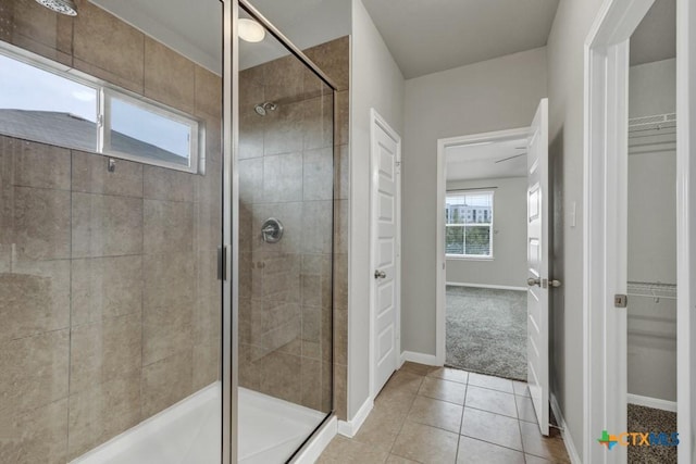 bathroom featuring tile patterned floors and a shower with door