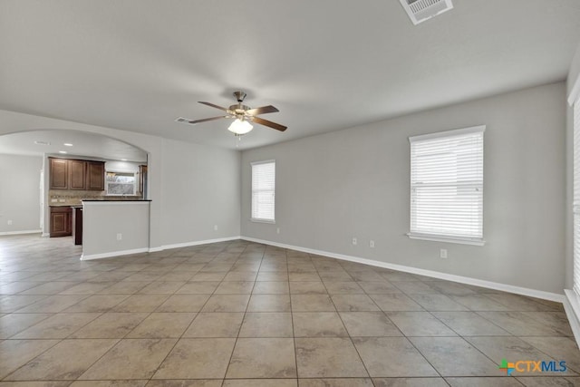 spare room featuring ceiling fan and light tile patterned floors