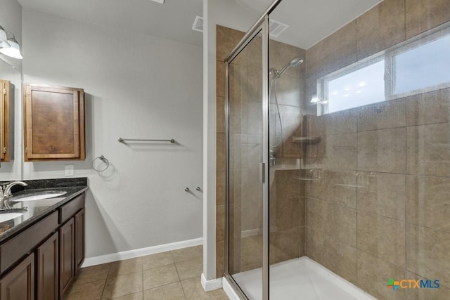 bathroom featuring vanity, tile patterned floors, and a shower with shower door