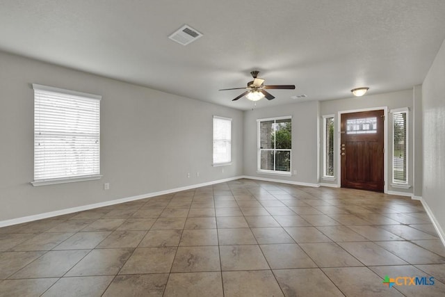 entrance foyer featuring light tile patterned floors and ceiling fan