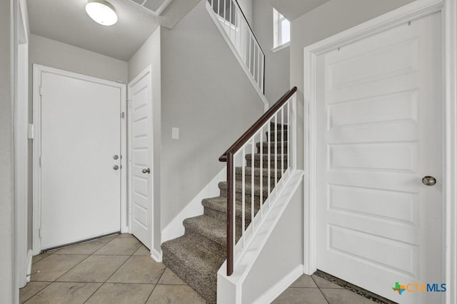 foyer entrance featuring light tile patterned floors