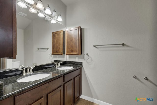 bathroom with tile patterned floors, vanity, and toilet