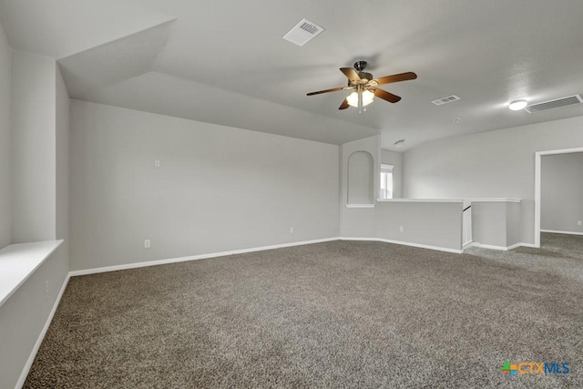 carpeted empty room with vaulted ceiling and ceiling fan