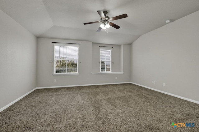 carpeted empty room with lofted ceiling and ceiling fan