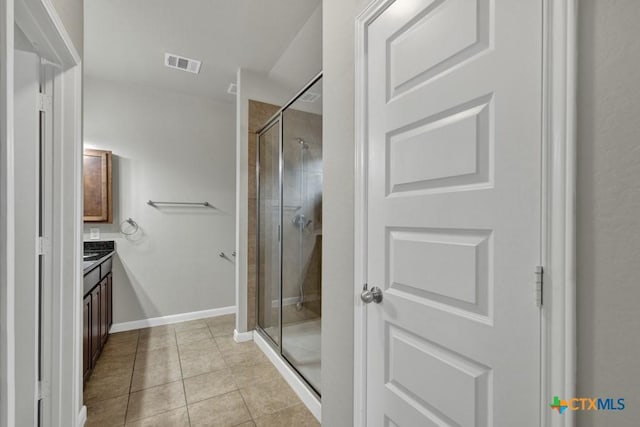 bathroom featuring an enclosed shower, vanity, and tile patterned floors