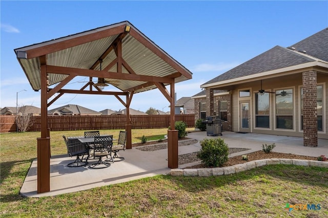 view of patio with a ceiling fan, a grill, a gazebo, and fence