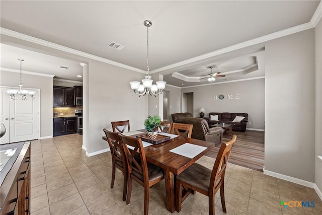 dining area featuring light tile patterned floors, ceiling fan with notable chandelier, visible vents, and baseboards