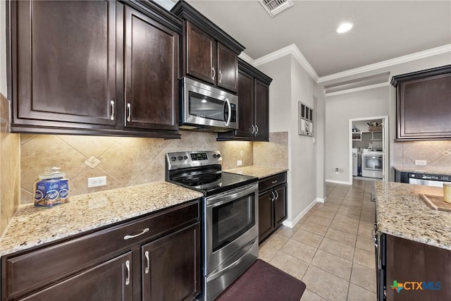 kitchen with light tile patterned floors, stainless steel appliances, visible vents, ornamental molding, and light stone countertops