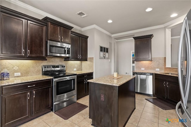 kitchen with light tile patterned floors, visible vents, appliances with stainless steel finishes, and a center island