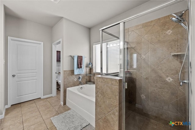 full bathroom featuring a bidet, a garden tub, toilet, tile patterned floors, and a stall shower