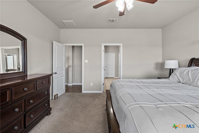 bedroom with a ceiling fan, visible vents, light carpet, and baseboards